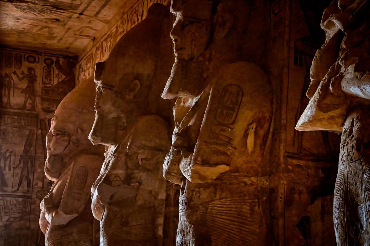 Statues inside the Holy of Holies at Abu Simbel illuminated by sunlight