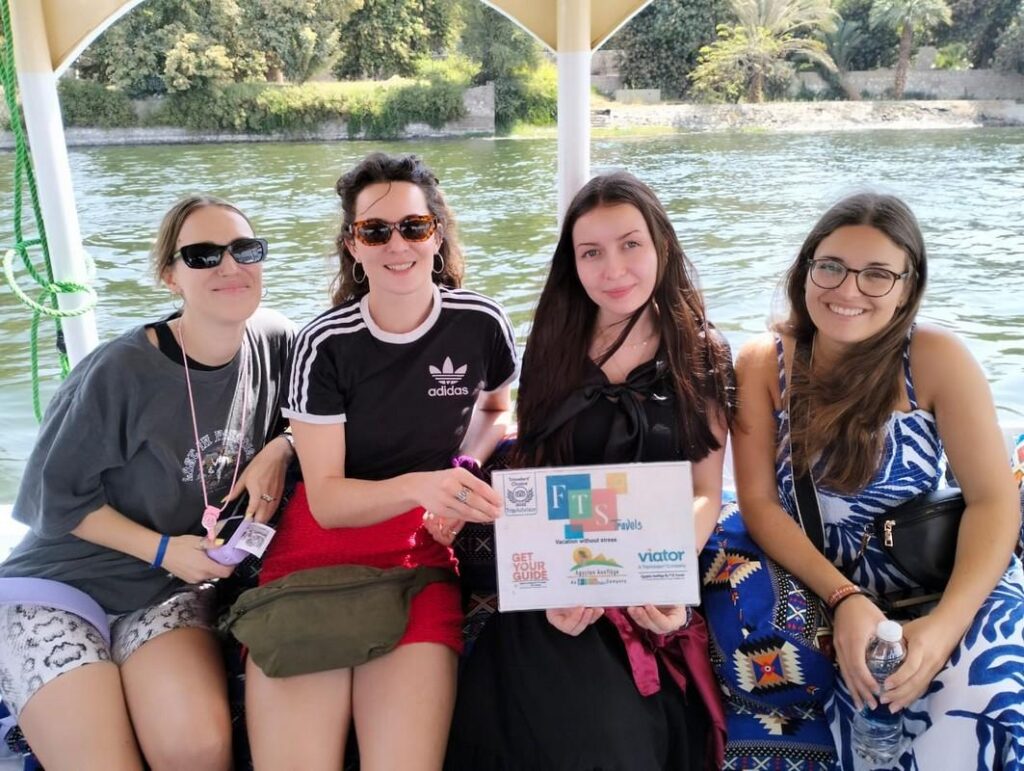 Four friends on a boat ride along the Nile River