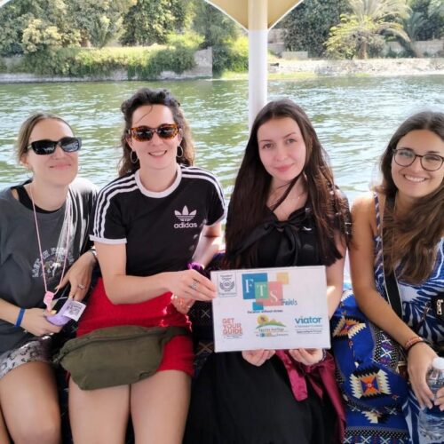Four friends on a boat ride along the Nile River