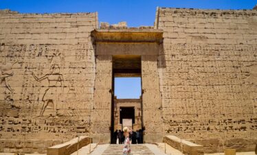 Visitor at the grand entrance with hieroglyphics