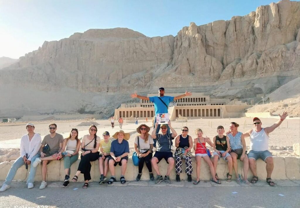Travelers posing in front of Hatshepsut Temple in Luxor.
