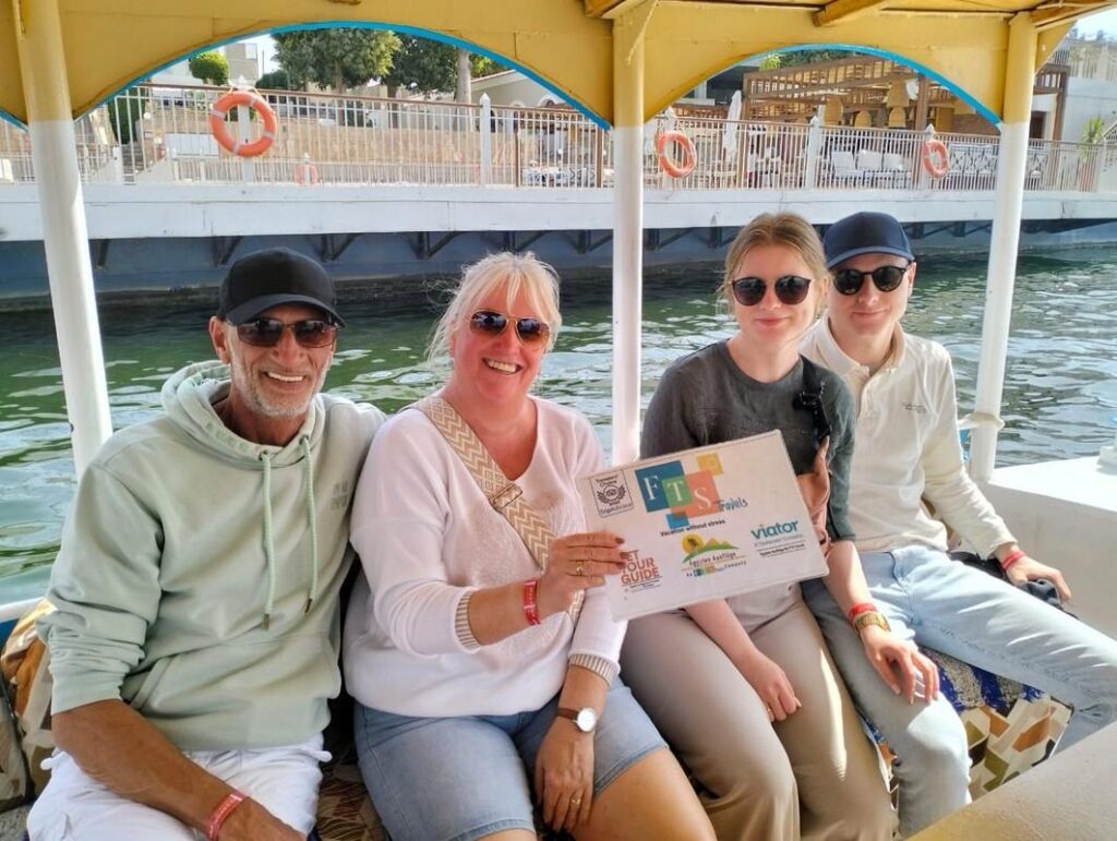 Family on a boat with a tour sign on the Nile