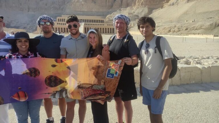 Tourists posing with Hatshepsut Temple in the background