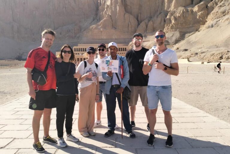 Tourists posing in front of Hatshepsut Temple in Luxor.