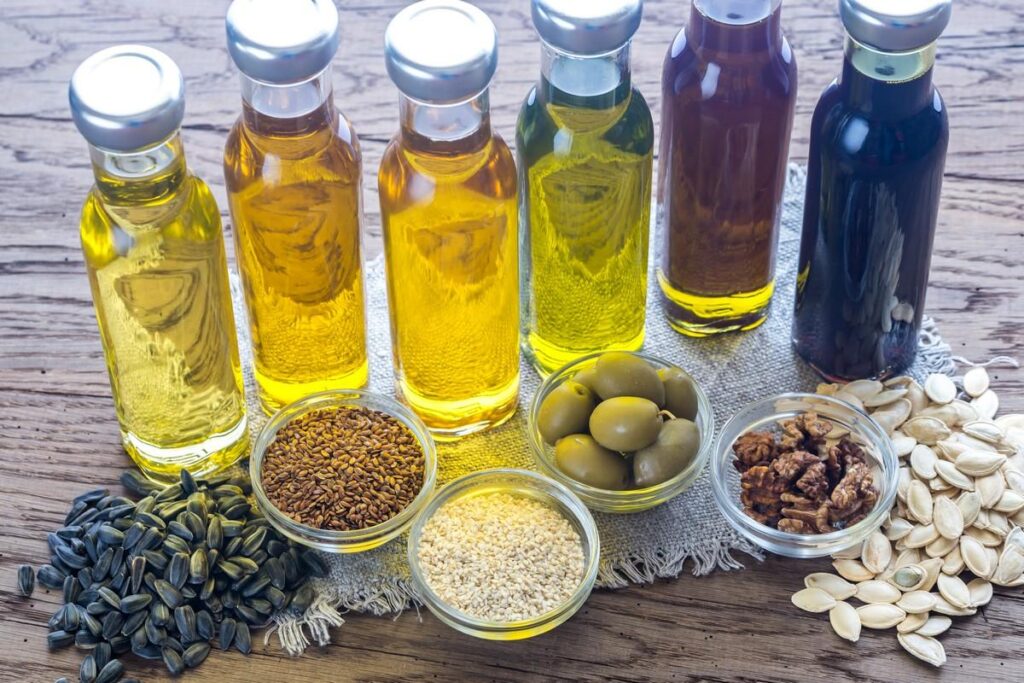 Bottles of oils and bowls of seeds and olives