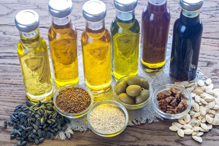 Bottles of oils and bowls of seeds and olives