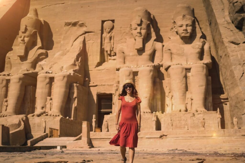 Woman in red dress near the Great Temple of Ramses