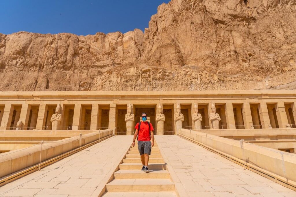 A person ascending the steps of the Temple of Hatshepsut.