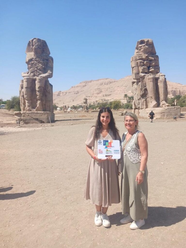 Two women in front of the Colossi of Memnon statues