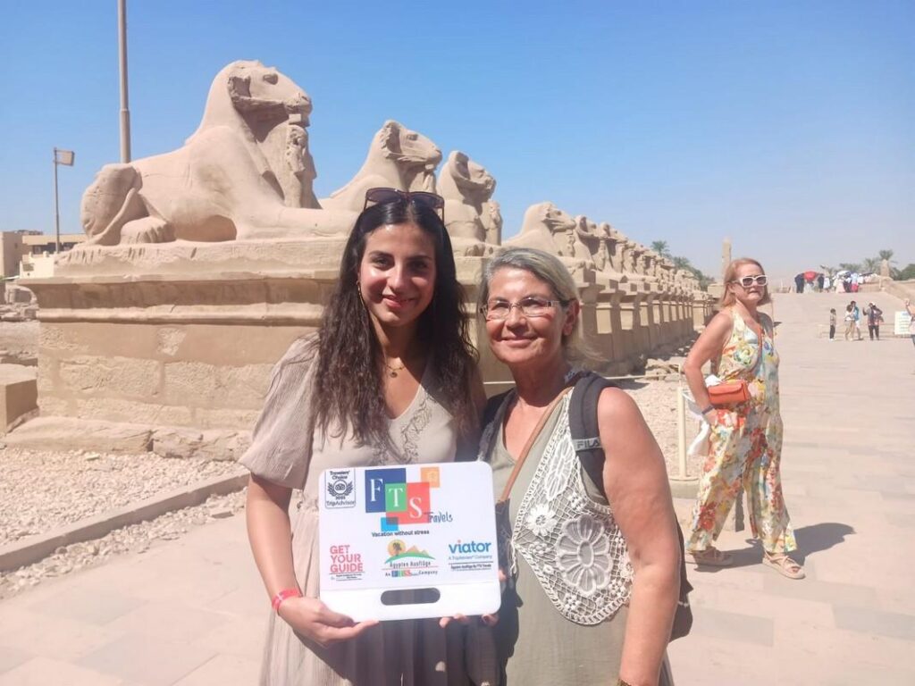 Two women with Sphinx statues in Luxor Egypt.